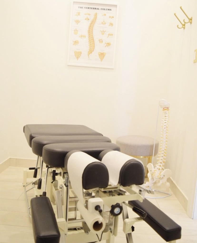 An empty chiropractic table is prepared and ready for the next client to receive treatment for their neck pain or back pain