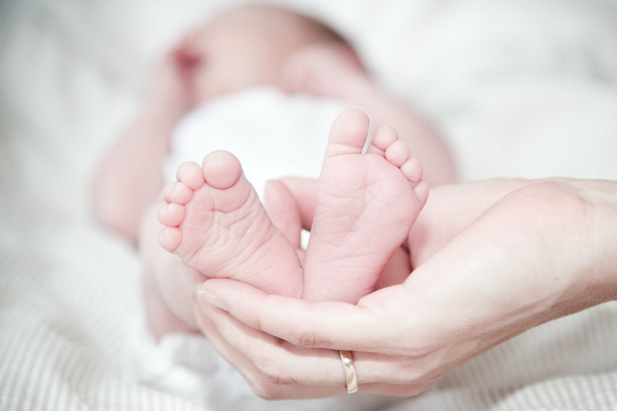 A mother holds her newborn baby&